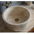 Round beige travertine sink